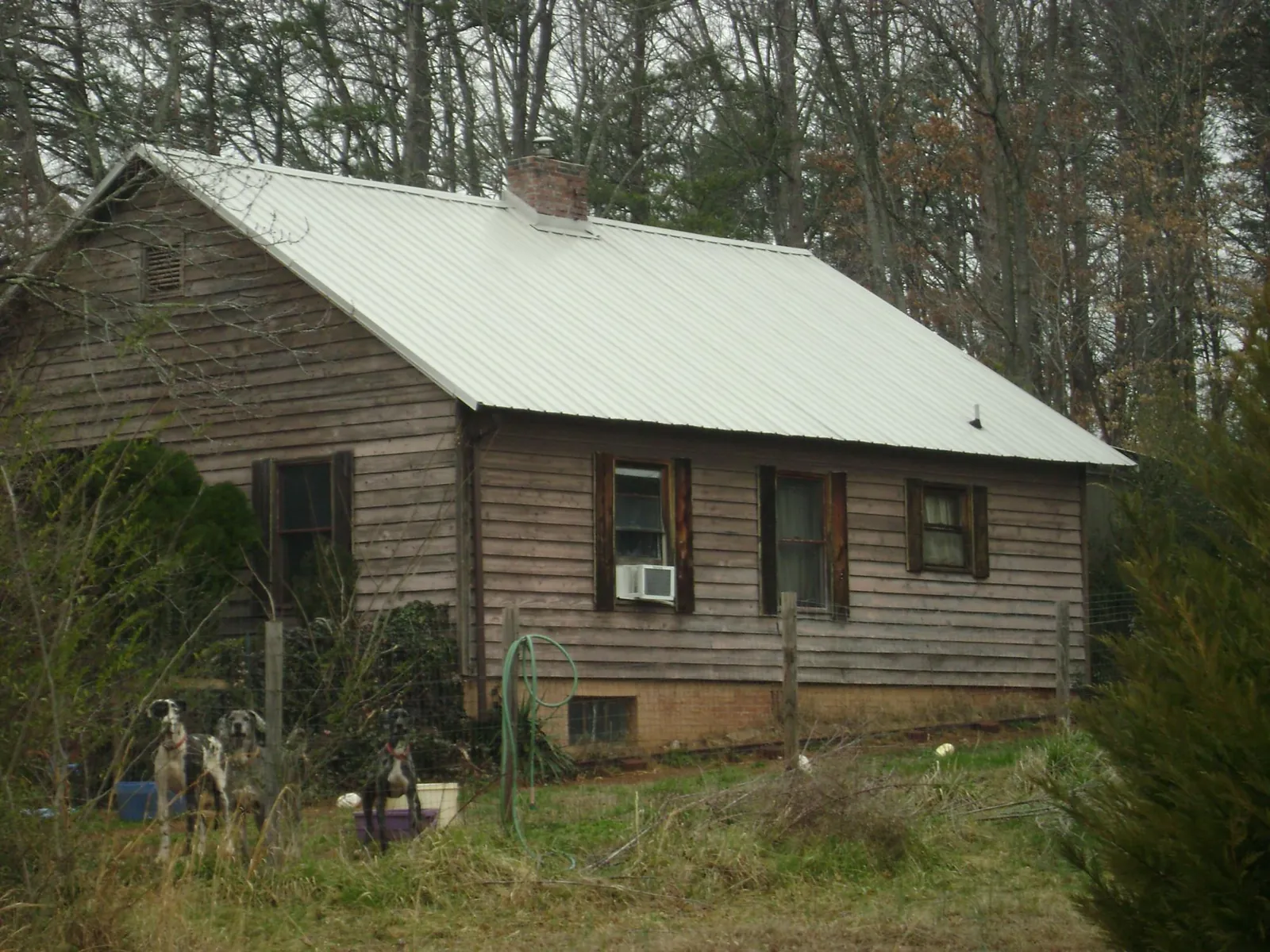 White metal roof on an old wood sided farmhouse, from a Metal Roof Installation job in Elmwood Park